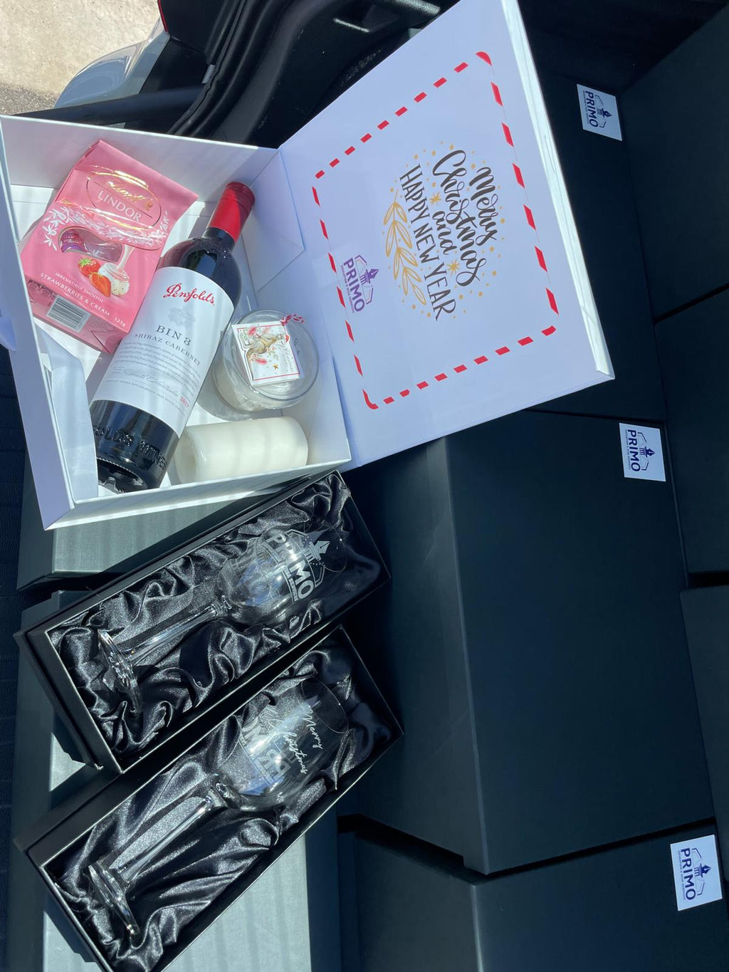 Christmas gift box with wine, chocolates and engraved branded glassware