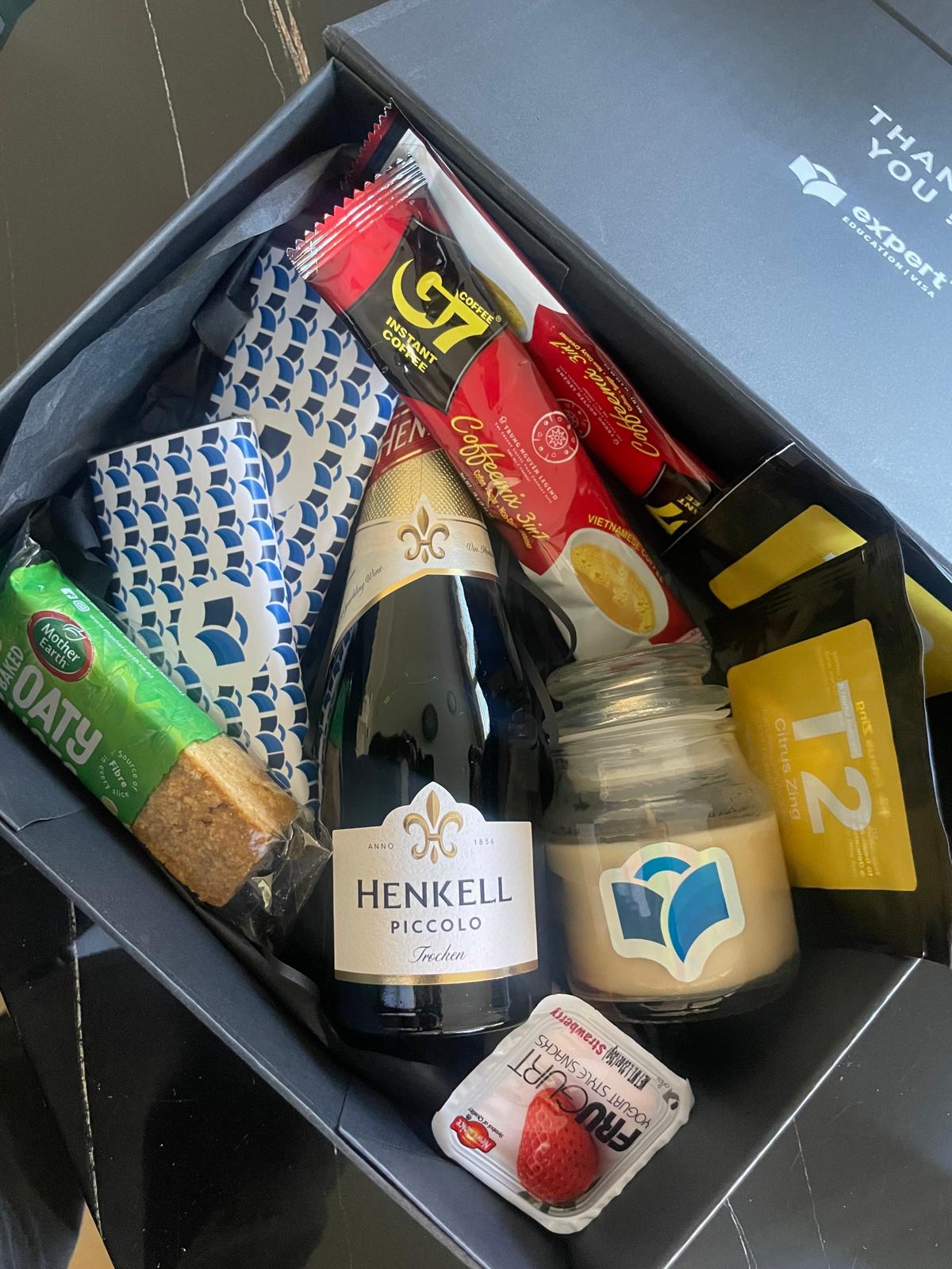 Branded corporate gift box with curated gourmet contents and logo candle